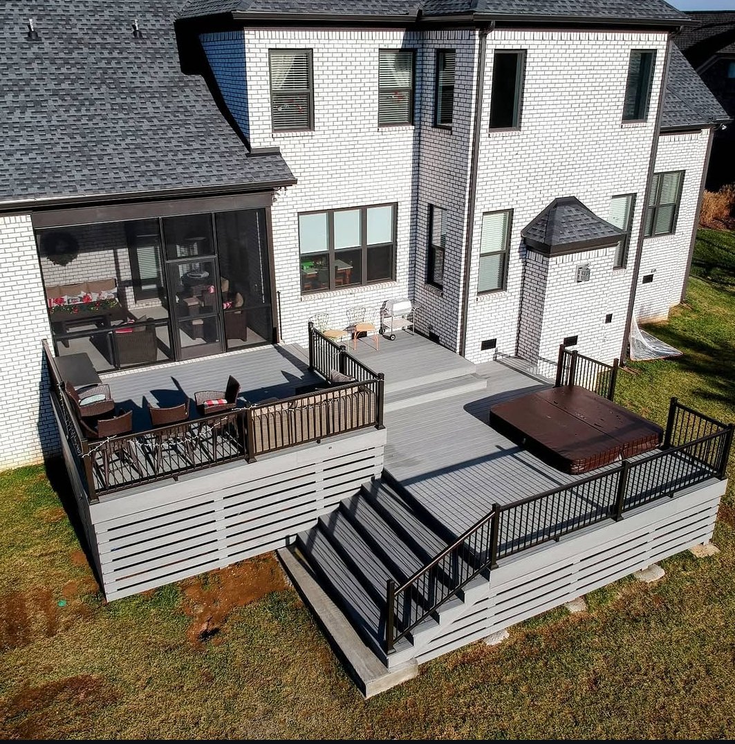 Multi-level composite deck with black aluminum railing built by KerrDecks